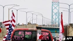 Supporters of the Truckers Convoy against the Covid-19 vaccine mandate block traffic in the Canada bound lanes of the Ambassador Bridge border crossing, in Windsor, Ontario, on Feb. 8, 2022.