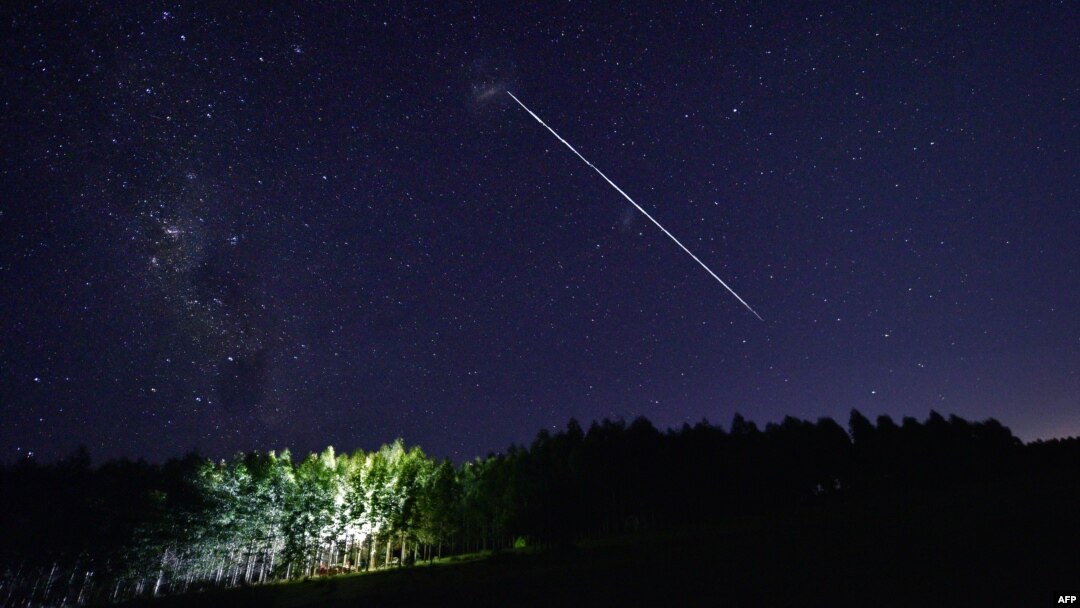 FILE - This time-exposure image shows a trail of a group of SpaceX's Starlink satellites passing over Uruguay, some 185 km north of Montevideo, Feb. 6, 2021. Up to 40 SpaceX high-speed internet satellites were knocked out of orbit by a geomagnetic storm s