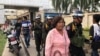 Three military policemen armed with guns patrol near Cambodia-Thailand border checkpoint in Poipet, Banteay Meanchey province, on Nov. 7, 2019. (Sun Narin/VOA Khmer)