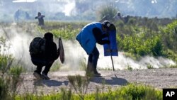 Squatters clash with police evicting them from a field where they lived in Guernica, Buenos Aires province, Argentina, Oct. 29, 2020. 