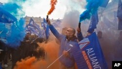 Police officers carrying union flags and flares gather outside the French justice ministry in Paris, part of police protests across France to demand better working conditions, Oct. 14, 2015.