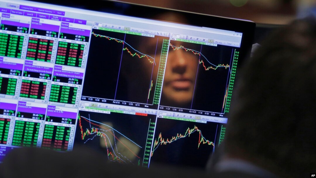 Specialist Frank Masiello is reflected in his screen on the floor of the New York Stock Exchange, Aug. 24, 2015.