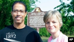 FILE - Keith Plessy and Phoebe Ferguson, descendants of the principals in the Plessy v. Ferguson court case, pose for a photograph in front of a historical marker in New Orleans, on June 7, 2011.