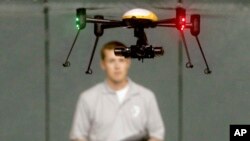 FILE - Students at John D. Odegard School of Aerospace Sciences at the University of North Dakota in Grand Forks, North Dakota, remotely pilot a drone during a demonstration, in a June 24, 2014, photo.