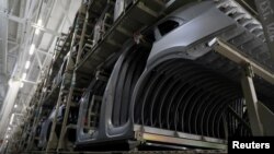 FILE - Audi Q5 parts are seen before an assembly line of the German car manufacturer's plant during a media tour in San Jose Chiapa, Mexico, April 19, 2018. 