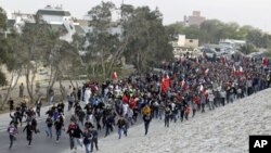 Anti-government protesters run toward Farooq Junction, also known as Pearl Square, after breaking barriers set up by police during a protest in Budaiya, west of Manama, Bahrain, February 13, 2012.
