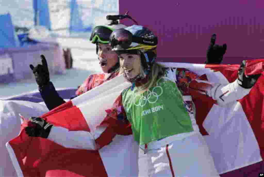 Czech Republic's Eva Samkova, left, celebrates after taking the gold medal in the women's snowboard cross final, with silver medalist Dominique Maltais of Canada at the Rosa Khutor Extreme Park, at the 2014 Winter Olympics, Sunday, Feb. 16, 2014, in Krasn