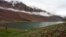 Tourists look at clouds hanging over Chandra Taal Lake in the Lahoul & Spiti district, in the northern Indian state of Himachal Pradesh, July 15, 2009. 