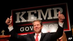FILE - Georgia Republican gubernatorial candidate Brian Kemp gives a thumbs-up to supporters in Athens, Ga., Nov. 7, 2018. 