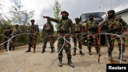 FILE - Indian army soldiers stand guard inside their army base after it was attacked by suspected separatist militants in Panzgam in Kashmir's Kupwara district, April 27, 2017. 