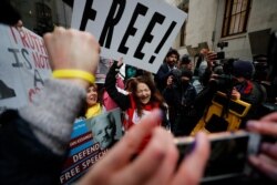 Julian Assange supporters celebrate after a ruling that he cannot be extradited to the United States, outside the Old Bailey in London, Jan. 4, 2021.