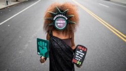 FILE - In this Saturday, June 19, 2021 photo, artist Lydia Mallett, of Trinidad and Tobago, attends Juneteenth celebrations in the Harlem neighborhood of New York.