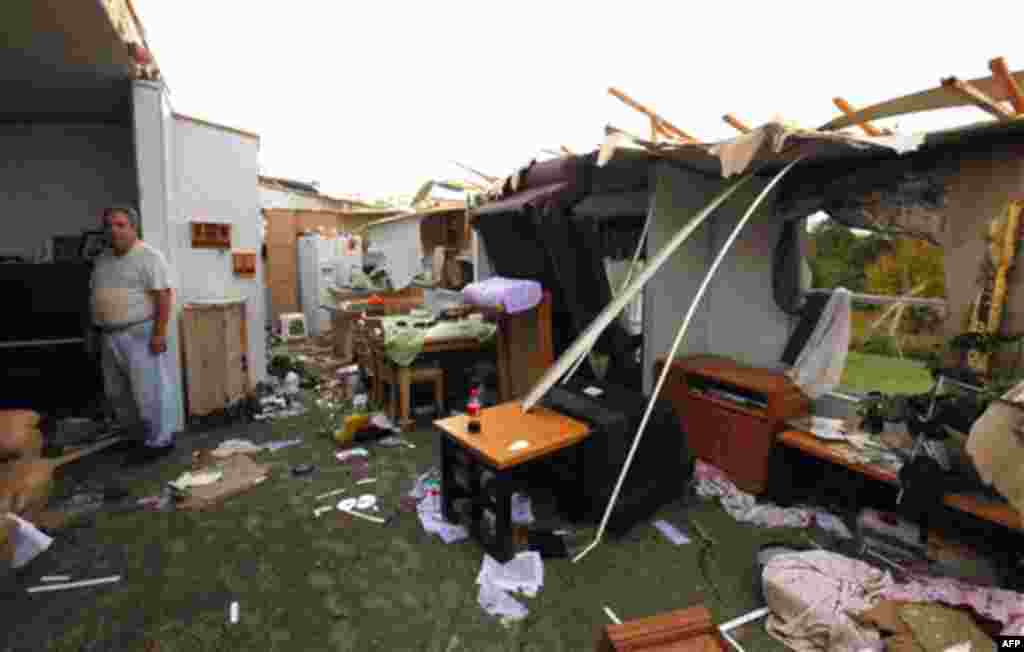 Jack Hambrick sits inside his destroyed home in Vale, N.C., U.S., Wednesday, Oct. 27, 2010 after powerful thunderstorms and tornadoes moved through the area. (AP Photo/Chuck Burton)