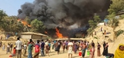 Smoke rises following a fire at the Rohingya refugee camp in Balukhali, southern Bangladesh, March 22, 2021.