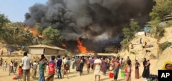 Smoke rises following a fire at the Rohingya refugee camp in Balukhali, southern Bangladesh, March 22, 2021.
