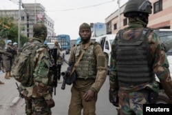 Members of the M23 rebel group supervise the exit of mercenary troops in the streets of Goma, eastern Democratic Republic of the Congo, amid conflict between them and the Armed Forces of the Democratic Republic of the Congo (FARDC), Jan. 29, 2025.