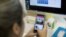 Luciana Santos shows the photo of puddles she sent via the app called “Sem Dengue,” or “Without Dengue,” in Niteroi, Brazil, March 8, 2016. 