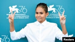 Actor Petr Kotlar flashes V-signs at the screening of "The Painted Bird" in Venice, Italy, Sept. 3, 2019. 