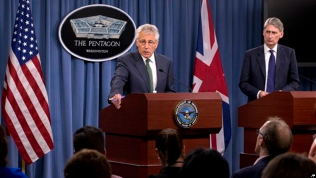 Defense Secretary Chuck Hagel, accompanied by British Defense Secretary Philip Hammond, addresses reporters following talks at the Pentagon, near Washington, May 2, 2013.