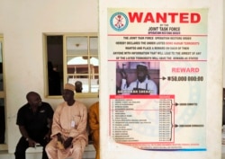 A poster advertising for the search of Boko Haram leader Abubakar Shekau is pasted on a wall in Baga village on the outskirts of Maiduguri, in the north-eastern state of Borno, Nigeria, May 13, 2013.