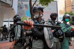 Riot police form a line as they plan to clear away people gathered in the Causeway Bay district in Hong Kong, May 27, 2020.