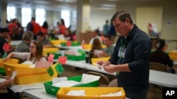 Election workers process mail-in ballots for the 2024 General Election at administrative offices in West Chester, Pennsylvania, Nov. 5, 2024.