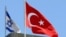 FILE - A Turkish flag flutters atop the Turkish embassy as an Israeli flag is seen nearby, in Tel Aviv, Israel, June 26, 2016.