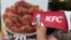 A customer holds a box of Kentucky Fried Chicken outside an KFC restaurant, Tuesday, July 13, 2010, in Mountain View, Calif. (AP Photo/Paul Sakuma)