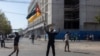 A man holds a Mozambican flag as members of the Islamic community of Mozambique march during a protest against the results of the 2024 presidential elections in Maputo on November 2, 2024.