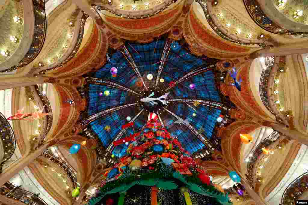 A giant Christmas tree stands at the Galeries Lafayette department store where lights were switched on for the festive season in Paris, France, Nov. 30, 2020.