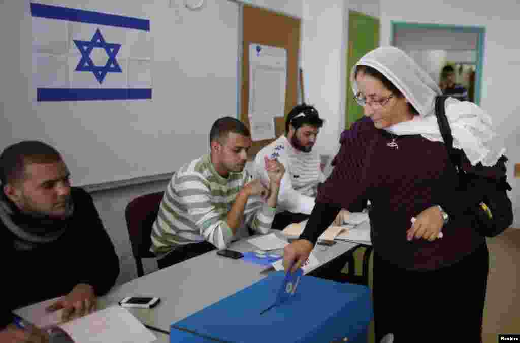 A Druze woman casts her ballot for the parliamentary election at a polling station in the northern Druze-Arab village of Maghar, Israel, January 22, 2013.