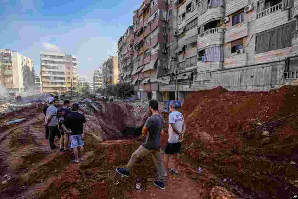 People gather at the site of the assassination of Hezbollah leader Hassan Nasrallah in Beirut&#39;s southern suburbs, Lebanon.