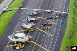 In this photo released by Military News Agency, Taiwan war planes are parked on a highway during an exercise in Changhua in southern Taiwan, May 28, 2019.