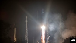 This photo provided by the CNES shows a Russian Soyuz rocket lifting off from the Kourou space base, French Guiana, early Wednesday Dec.18, 2019.