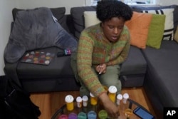 FILE—Jazmin Evans, a student at Temple University, prepares her post-kidney transplant medications at home in Philadelphia on February 16, 2024.