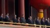 FILE - Chinese President Xi Jinping, center, stands with other Chinese leaders to watch a parade as Communist Party celebrates its 70th anniversary in Beijing, Oct. 1, 2019. 