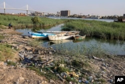 FILE - Fishing boats sit in the Shatt al-Arab waterway in Basra, Iraq on July 13, 2020. (AP Photo/Nabil al-Jurani, File)