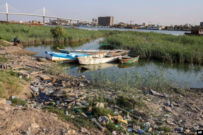 FILE - Fishing boats sit in the Shatt al-Arab waterway in Basra, Iraq on July 13, 2020. (AP Photo/Nabil al-Jurani, File)