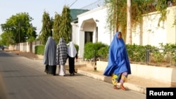 Women walk in a street in a residential area in Maiduguri, Borno State May 19, 2013.