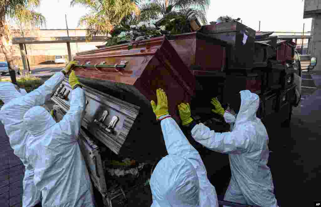 Workers collect and stack the coffins of people who have been recently cremated, at La Recoleta cemetery, amid the new coronavirus pandemic in Santiago, Chile, June 30, 2020.&#160;The coffins are&#160;destroyed by a company specializing in organic waste.&#160;