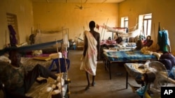 FILE - A man walks in a ward inside a hospital in Juba, South Sudan, Dec. 28, 2013.