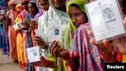 Women wait outside a voting location in Uttar Pradesh in 2007.