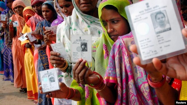 Women wait outside a voting location in Uttar Pradesh in 2007.