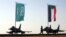 FILE - Military personnel walk past the flags of Saudi Arabia and Sudan at Merowe Airport in Merowe, Northern State, Sudan, April 9, 2017. 