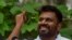 Anura Kumara Dissanayake, the presidential candidate from National People's Power, shows his ink-marked finger after casting his vote at a polling station, on the day of the presidential election, in Colombo, Sri Lanka, Sept. 21, 2024.