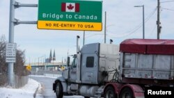 A commercial truck enters the entrance ramp to the Ambassador Bridge to Canada in Detroit, Michigan, Feb. 14, 2022.