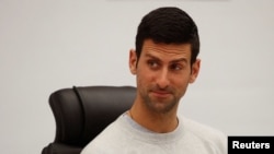 FILE - Novak Djokovic reacts during the "Honorary citizen of the city of Budva" award ceremony, in Budva, Montenegro, Jan. 28, 2022.