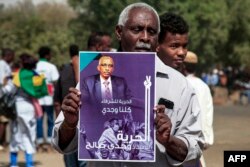 A man holds up a sign calling for the release of Sudanese activist and lawyer Wajdi Saleh during a demonstration calling for civilian rule and denouncing the military administration, in the south of Sudan's capital Khartoum, Feb. 10, 2022