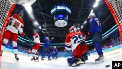 Members of the U.S. women's hockey team celebrate after scoring on Czech Republic at the 2022 Winter Olympics in Beijing, Feb. 12, 2022.