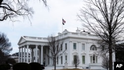 An American flag flies on top of the White House, Saturday, Feb. 12, 2022, in Washington. 